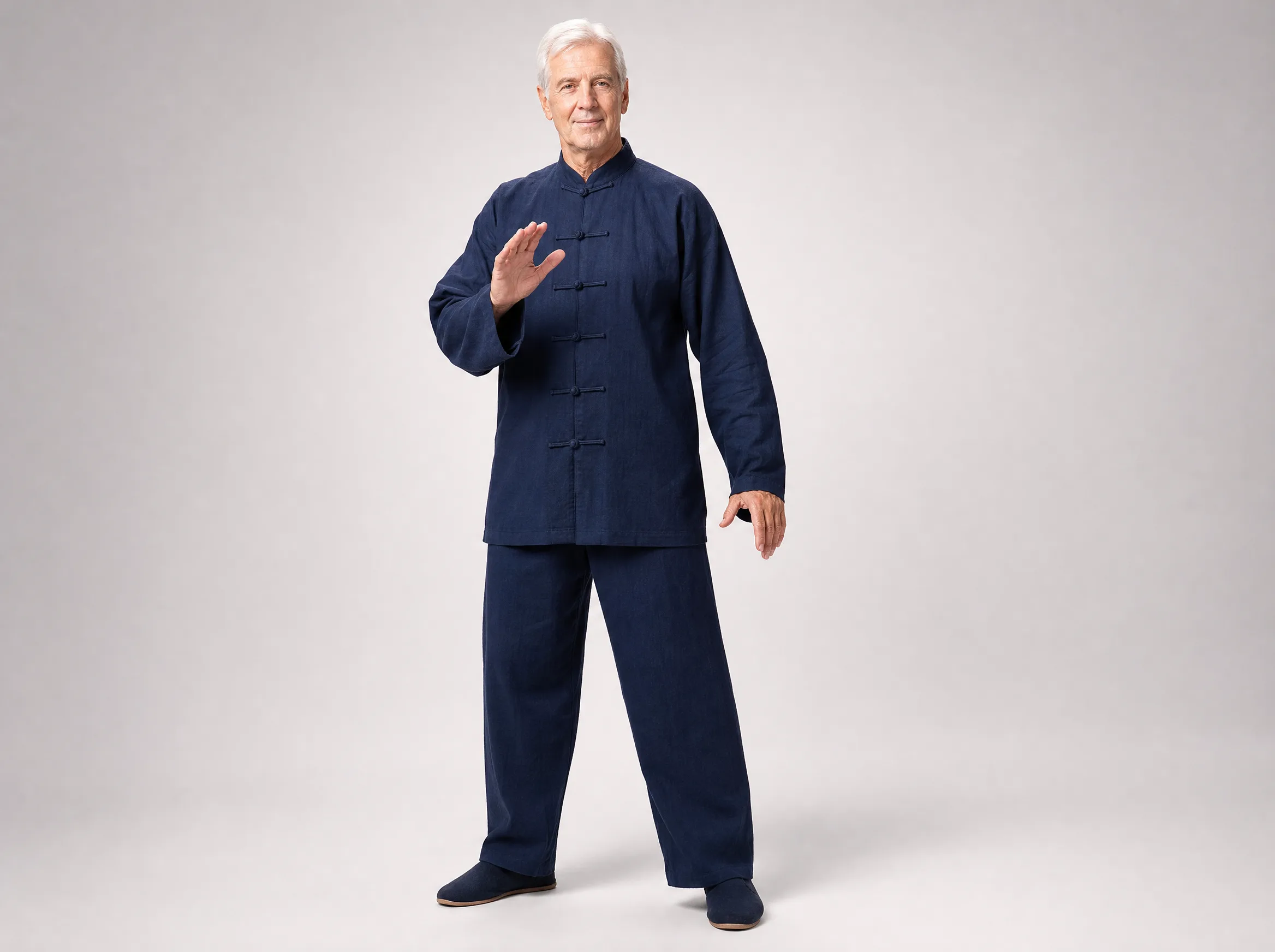Older Western man wearing a dark blue long-sleeve cotton-linen tai chi uniform