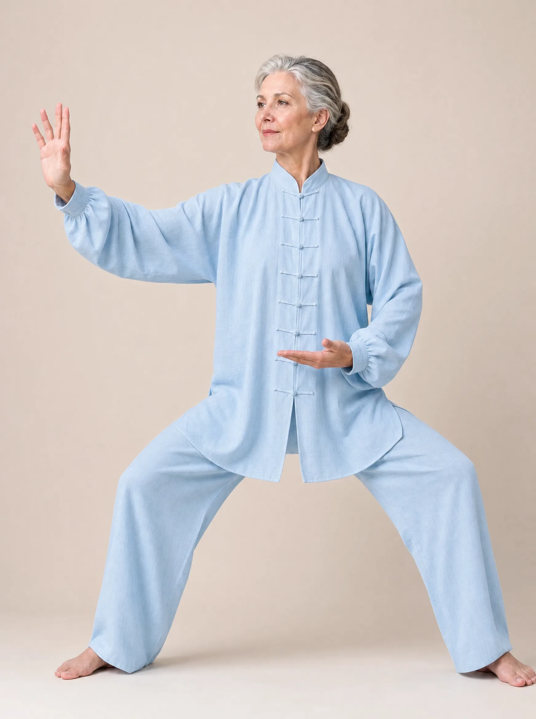 Older Western woman wearing a sky blue long-sleeve cotton-linen tai chi uniform