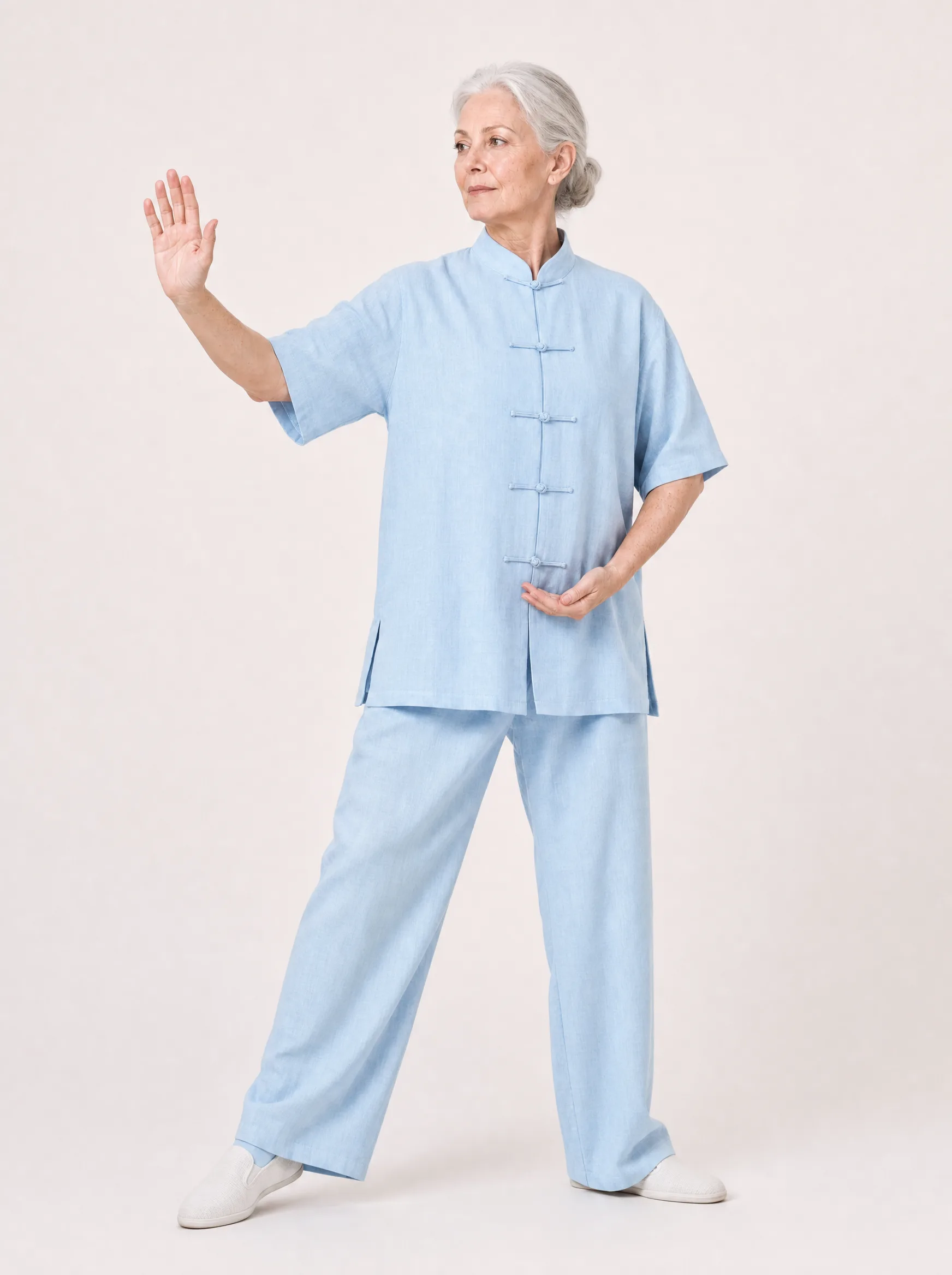 Older Western woman wearing a baby blue short-sleeve cotton-linen tai chi uniform