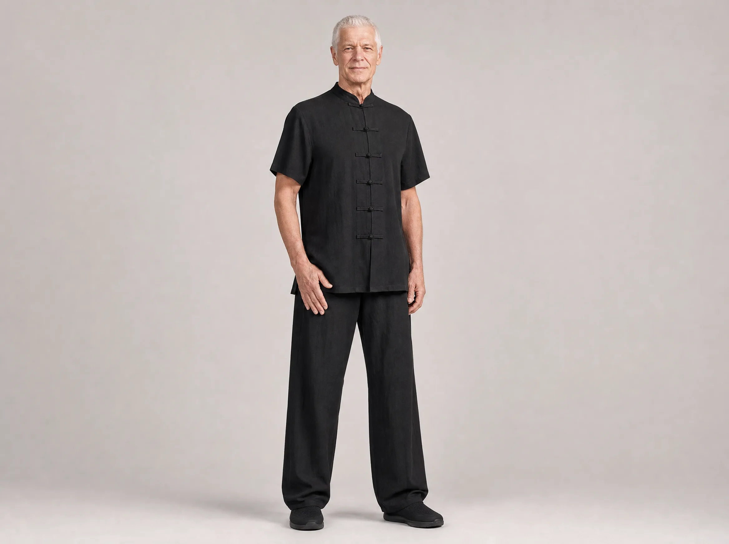 Older Western man wearing a black short-sleeve cotton-linen tai chi uniform