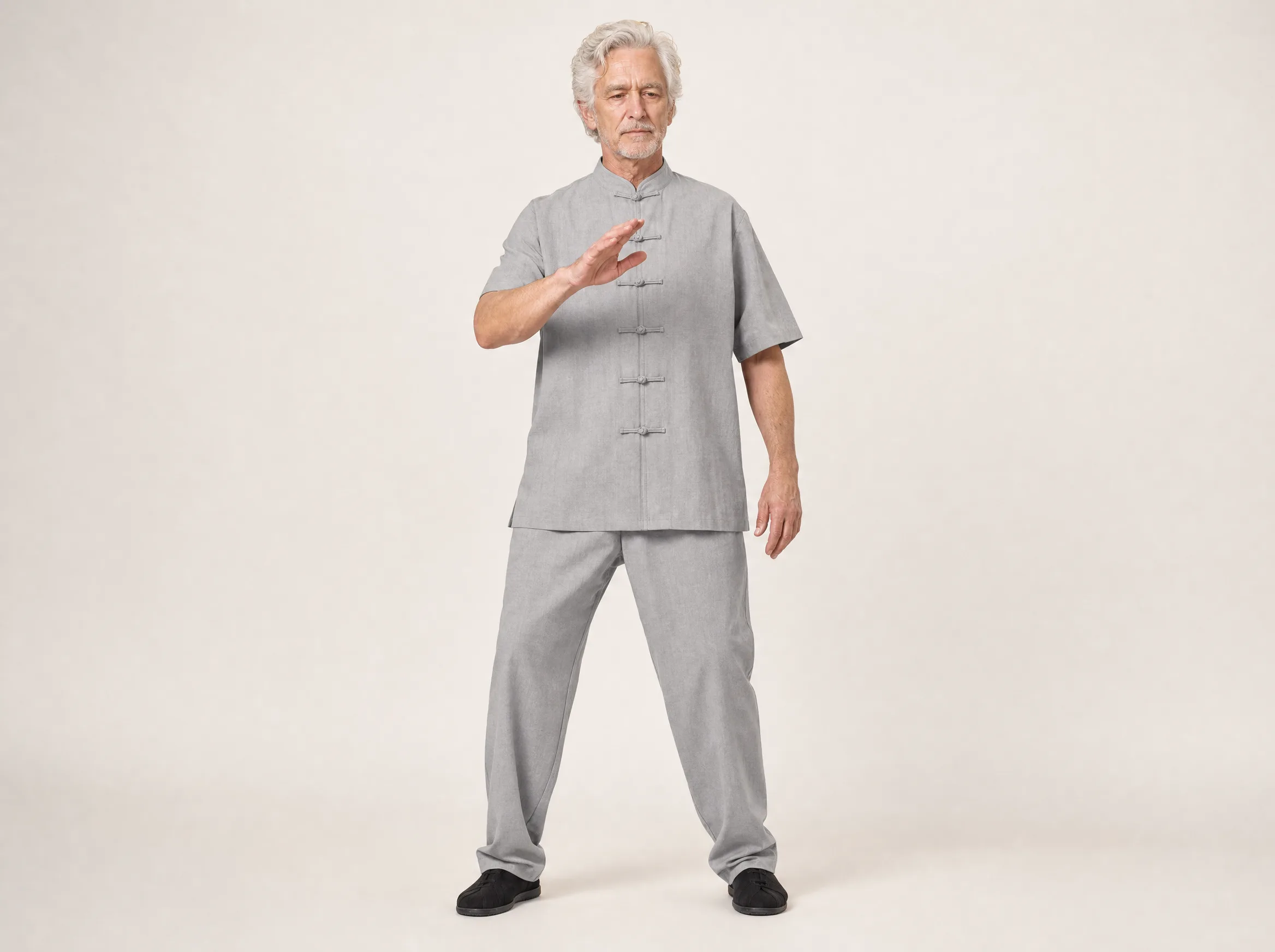 Older Western man wearing a light gray short-sleeve cotton-linen tai chi uniform
