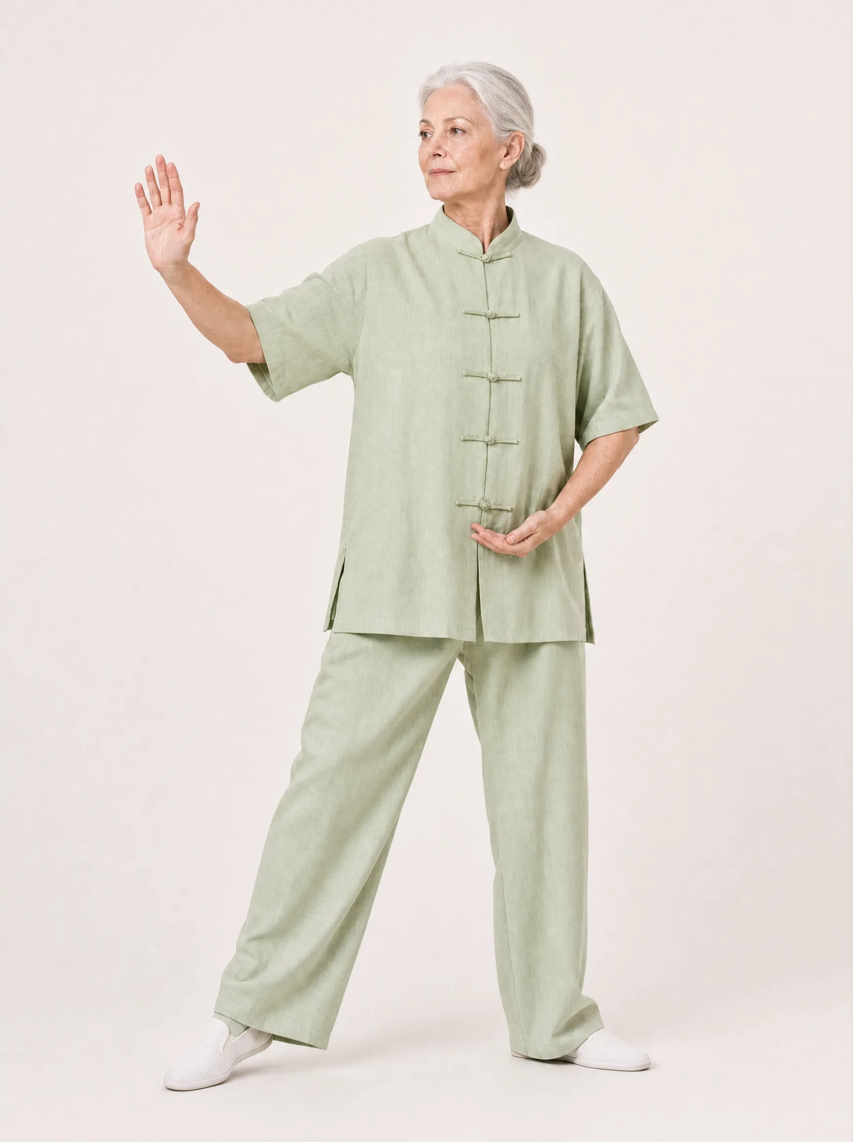 Older Western adult wearing a light green short-sleeve cotton-linen tai chi uniform